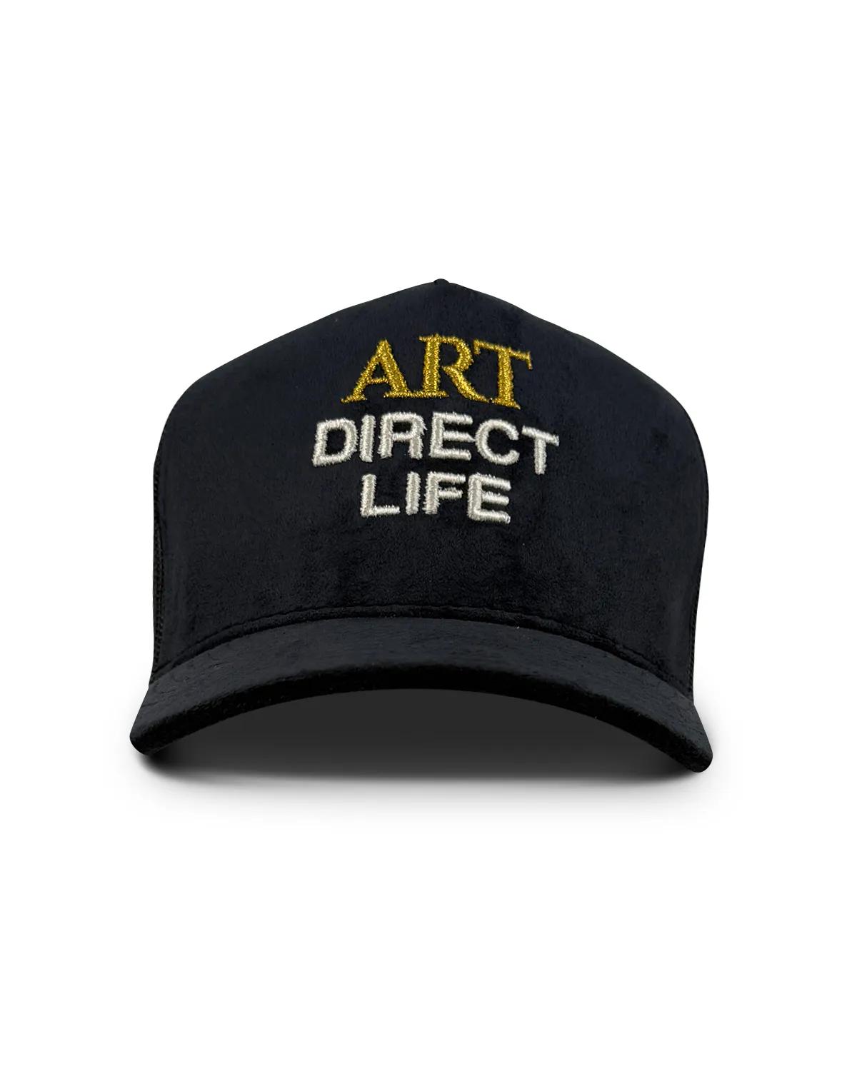 Dark suede trucker cap, front view, with ART embroidered in gold above DIRECT LIFE in white