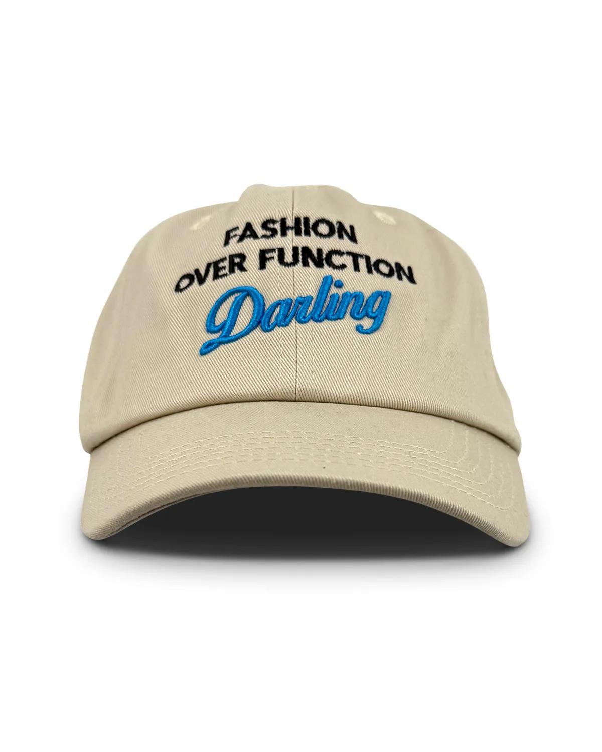 Beige unstructured dad cap, front view, with FASHION OVER FUNCTION arched above Darling in blue script