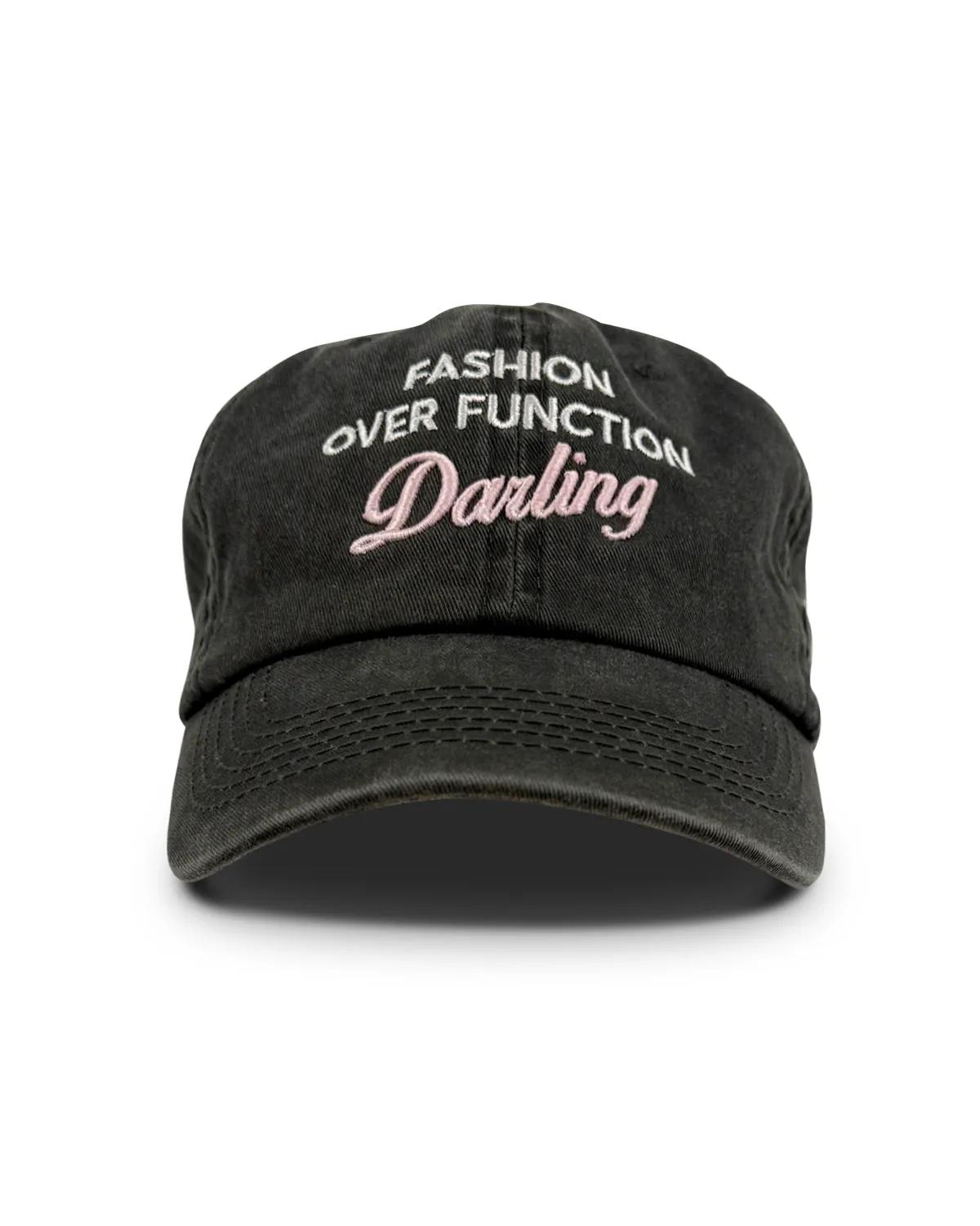 Washed grey denim dad cap, front view, with FASHION OVER FUNCTION arched above Darling in pink script