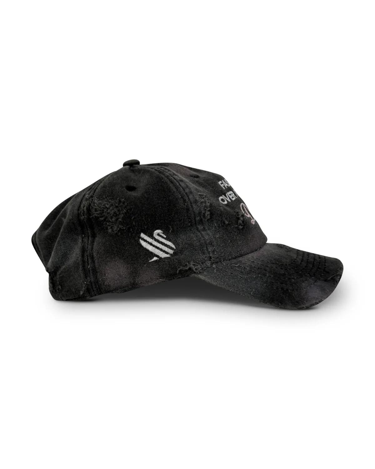 Distressed grey denim dad cap seen from the side, showing the frayed brim edge and the worn crown